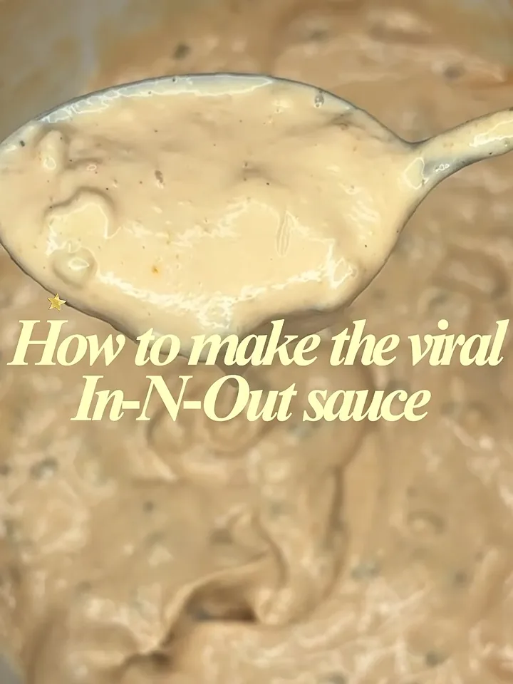 Overhead shot of a creamy sauce being spooned from a pan while being filmed